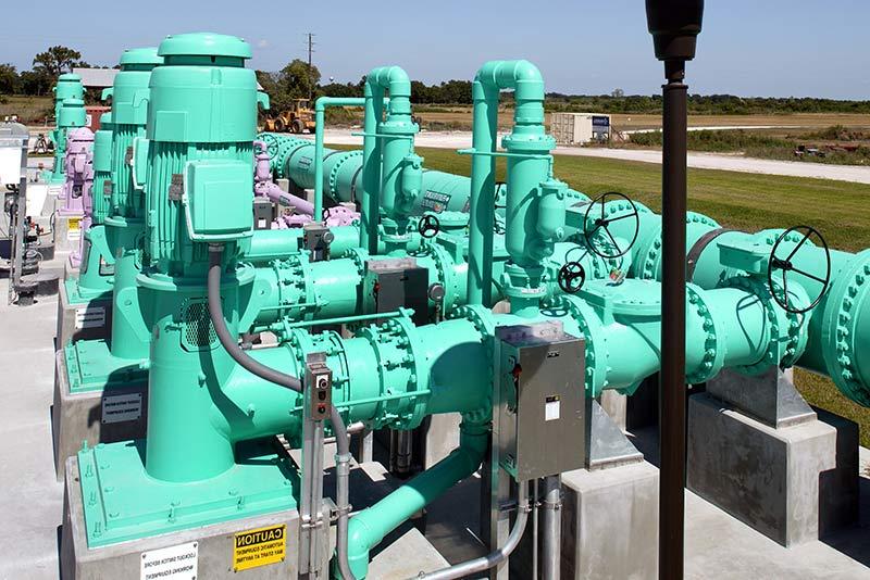 Green pipes and motors outside the facility